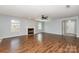 Spacious living room with hardwood floors, a fireplace, and ample natural light at 12829 Brandenburg Ln, Midland, NC 28107