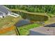 Aerial view of the home's backyard, fencing, a tranquil pond, and surrounding greenery at 1311 Rowan Ln, Monroe, NC 28110