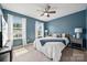Comfortable bedroom features plush carpet, two windows, and calming blue walls at 1311 Rowan Ln, Monroe, NC 28110
