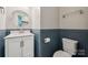 Charming half bathroom features modern fixtures, stylish vanity and clean finishes at 1311 Rowan Ln, Monroe, NC 28110