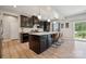 Stylish kitchen featuring dark wood cabinets, pendant lighting, a large island, and modern appliances at 1311 Rowan Ln, Monroe, NC 28110
