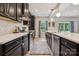 Elegant kitchen with stainless steel appliances, a center island, modern countertops, and dark cabinetry at 1311 Rowan Ln, Monroe, NC 28110