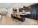 Modern kitchen with dark cabinetry, a center island with seating, and stainless steel appliances at 1311 Rowan Ln, Monroe, NC 28110