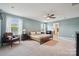 Spacious main bedroom with neutral tones, large windows, and a ceiling fan at 1311 Rowan Ln, Monroe, NC 28110