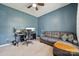 Stylish home office with modern desk setup, blue walls, comfortable seating, and ample space at 1311 Rowan Ln, Monroe, NC 28110