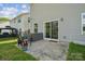 Home patio with chairs and a storage box, framed by sliding glass door and green yard at 1311 Rowan Ln, Monroe, NC 28110