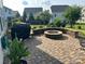 Charming backyard featuring a custom stone fire pit and a paved patio area, perfect for outdoor entertaining at 1349 Bridgeford Nw Dr, Huntersville, NC 28078