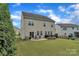 Beautiful large backyard features a patio with firepit and nice lawn space at 1349 Bridgeford Nw Dr, Huntersville, NC 28078