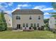 Spacious backyard featuring a stone fire pit and patio seating area, perfect for outdoor gatherings at 1349 Bridgeford Nw Dr, Huntersville, NC 28078