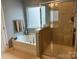 Bathroom featuring a garden tub, a shower, and a window at 1349 Bridgeford Nw Dr, Huntersville, NC 28078