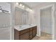 Bathroom showcasing a dual sink vanity with brown cabinets at 1349 Bridgeford Nw Dr, Huntersville, NC 28078