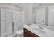 Bathroom featuring a glass shower door, vanity, mirror, and white walls at 1349 Bridgeford Nw Dr, Huntersville, NC 28078