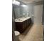 Bathroom with a brown vanity, a light countertop, and a toilet at 1349 Bridgeford Nw Dr, Huntersville, NC 28078