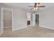 Light filled bedroom with carpeted floors, walk-in closet and en suite bathroom at 1349 Bridgeford Nw Dr, Huntersville, NC 28078