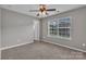 Empty bedroom featuring gray walls, a window, and carpet flooring at 1349 Bridgeford Nw Dr, Huntersville, NC 28078