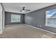 Large, carpeted bedroom with natural light and neutral walls and a ceiling fan at 1349 Bridgeford Nw Dr, Huntersville, NC 28078