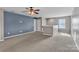 Spacious bonus room with carpet, ceiling fan, and a bright window at 1349 Bridgeford Nw Dr, Huntersville, NC 28078