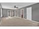 Spacious bonus room featuring natural light, ceiling fan, and convenient entryways at 1349 Bridgeford Nw Dr, Huntersville, NC 28078