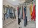 Walk-in closet with hanging clothes and shelving at 1349 Bridgeford Nw Dr, Huntersville, NC 28078