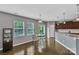 Cozy dining area adjacent to the kitchen, featuring hardwood floors and natural light with backyard access at 1349 Bridgeford Nw Dr, Huntersville, NC 28078