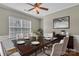Charming dining room featuring modern decor, a ceiling fan, and large windows at 1349 Bridgeford Nw Dr, Huntersville, NC 28078