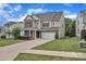 Attractive two-story home with brick and siding, a two-car garage, and a well-manicured lawn at 1349 Bridgeford Nw Dr, Huntersville, NC 28078