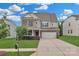 Beautiful two-story home with a brick and tan exterior, well-manicured lawn, and an attached two-car garage at 1349 Bridgeford Nw Dr, Huntersville, NC 28078