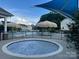 Relaxing hot tub with a view of the community pool, offering a perfect retreat for unwinding at 1349 Bridgeford Nw Dr, Huntersville, NC 28078