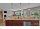 Open kitchen featuring granite countertops, stainless steel appliances, and seamless flow to the living area at 1349 Bridgeford Nw Dr, Huntersville, NC 28078