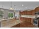 Well-equipped kitchen featuring granite counters, stainless appliances, hardwood floors, and ample cabinet space at 1349 Bridgeford Nw Dr, Huntersville, NC 28078