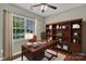 Bright home office with a large window, built-in shelving, and hardwood floors at 1349 Bridgeford Nw Dr, Huntersville, NC 28078
