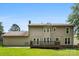 Home's backyard has a wooden deck that is accessible through double doors, vinyl siding, and a lush lawn at 14402 Raynham Dr, Charlotte, NC 28262