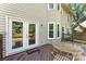 Backyard deck with table and chairs is accessible through white double doors off the side of the home at 14402 Raynham Dr, Charlotte, NC 28262