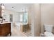 Bathroom featuring a soaking tub, a glass shower, and an elegant vanity with a marble countertop at 14402 Raynham Dr, Charlotte, NC 28262