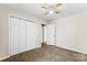Bedroom with neutral walls, closet, carpet flooring, ceiling fan, and a window that offers natural light at 14402 Raynham Dr, Charlotte, NC 28262