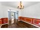 Elegant dining room with hardwood floors, wainscoting, and a chandelier, perfect for formal gatherings at 14402 Raynham Dr, Charlotte, NC 28262