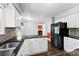Well-appointed kitchen with granite countertops, mosaic backsplash, and modern appliances, offering style and functionality at 14402 Raynham Dr, Charlotte, NC 28262