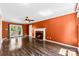 Inviting living room featuring hardwood floors, a fireplace with hearth, and access to an outdoor deck at 14402 Raynham Dr, Charlotte, NC 28262
