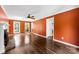 Spacious living room with hardwood floors, a brick fireplace, and ample natural light from large windows at 14402 Raynham Dr, Charlotte, NC 28262