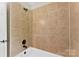 This tiled shower includes a bronze shower head and faucet with matching fixtures at 14402 Raynham Dr, Charlotte, NC 28262