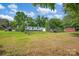 Open backyard showcasing the home, garage, outbuilding, and vast green space perfect for outdoor activities at 1532 Buffalo Shoals Rd, Claremont, NC 28610