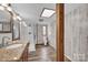 Modern bathroom featuring a glass-enclosed shower, granite vanity, and stylish wood paneling at 1532 Buffalo Shoals Rd, Claremont, NC 28610