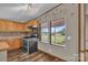 Cozy kitchen with wooden cabinets, view from a large window, and stainless steel stove at 1532 Buffalo Shoals Rd, Claremont, NC 28610