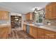 Well-appointed kitchen with wooden cabinets, stainless steel sink, and view from the large window at 1532 Buffalo Shoals Rd, Claremont, NC 28610
