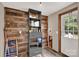 Laundry area and storage with wood-look walls and shelving units, plus a door to the outside at 1532 Buffalo Shoals Rd, Claremont, NC 28610