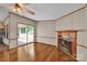 Bright living room with a cozy fireplace and sliding glass doors leading to a wooden deck at 1532 Buffalo Shoals Rd, Claremont, NC 28610