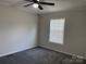 This bedroom features neutral walls, plush carpet and a single window for natural light at 1555 Moore Rd, York, SC 29745