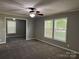 Inviting living room featuring neutral walls, plush carpet and three large windows at 1555 Moore Rd, York, SC 29745