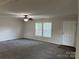 Bright living room featuring neutral walls, two large windows and ceiling fan at 1555 Moore Rd, York, SC 29745