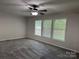 Well-lit living room featuring neutral walls, plush carpet and three large windows at 1555 Moore Rd, York, SC 29745